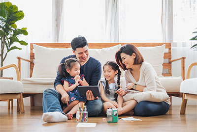 Family sitting on floor talking to each other.